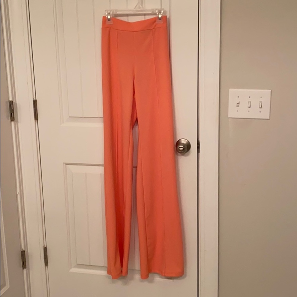 Peach colored long, high waisted trousers